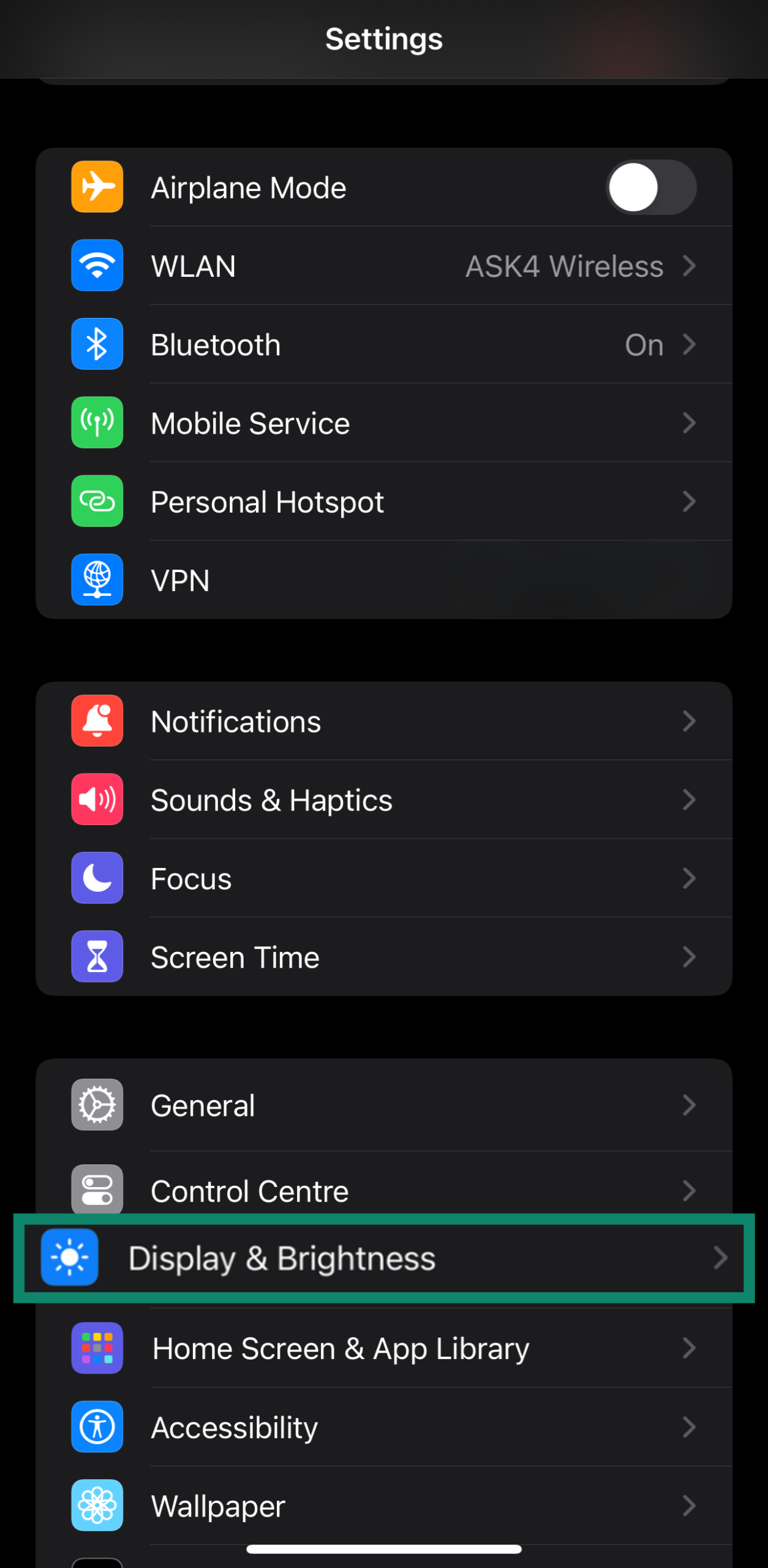 Accessing Display & Brightness settings on an iPhone through the settings menu